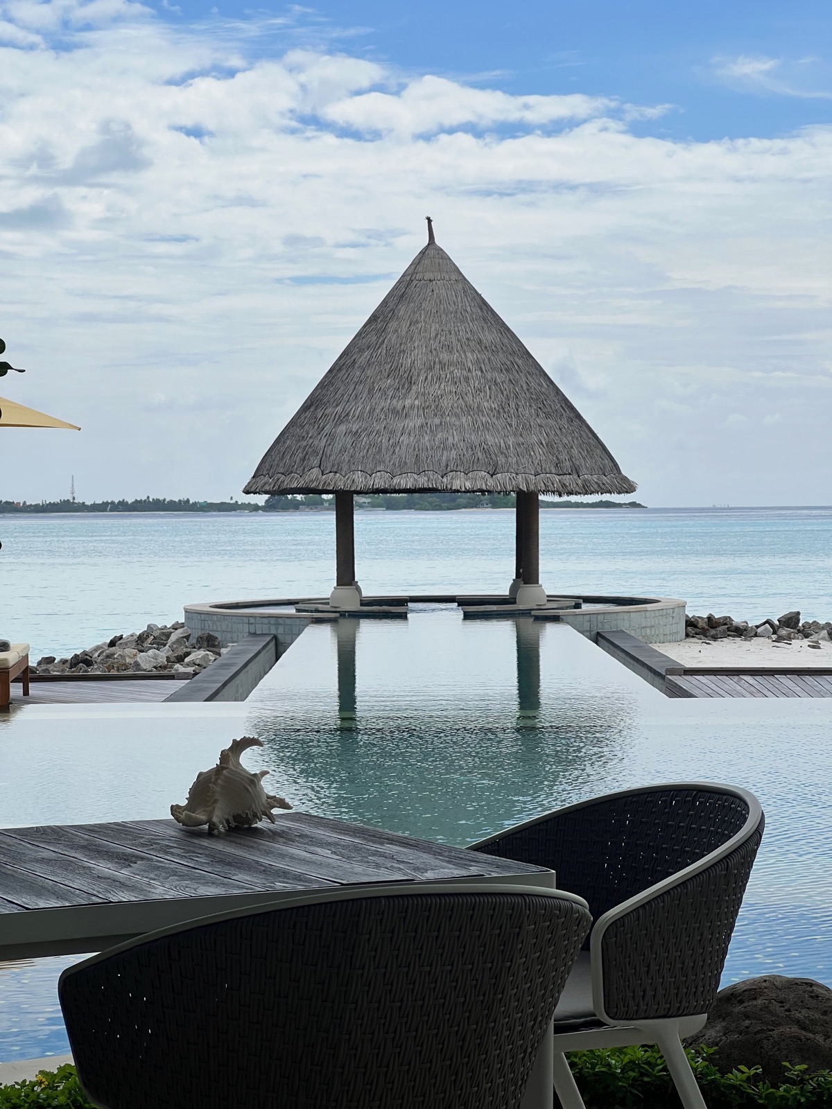 Pool and thatched pavilion beside the sea at Kuda Huraa, photographed by Brian