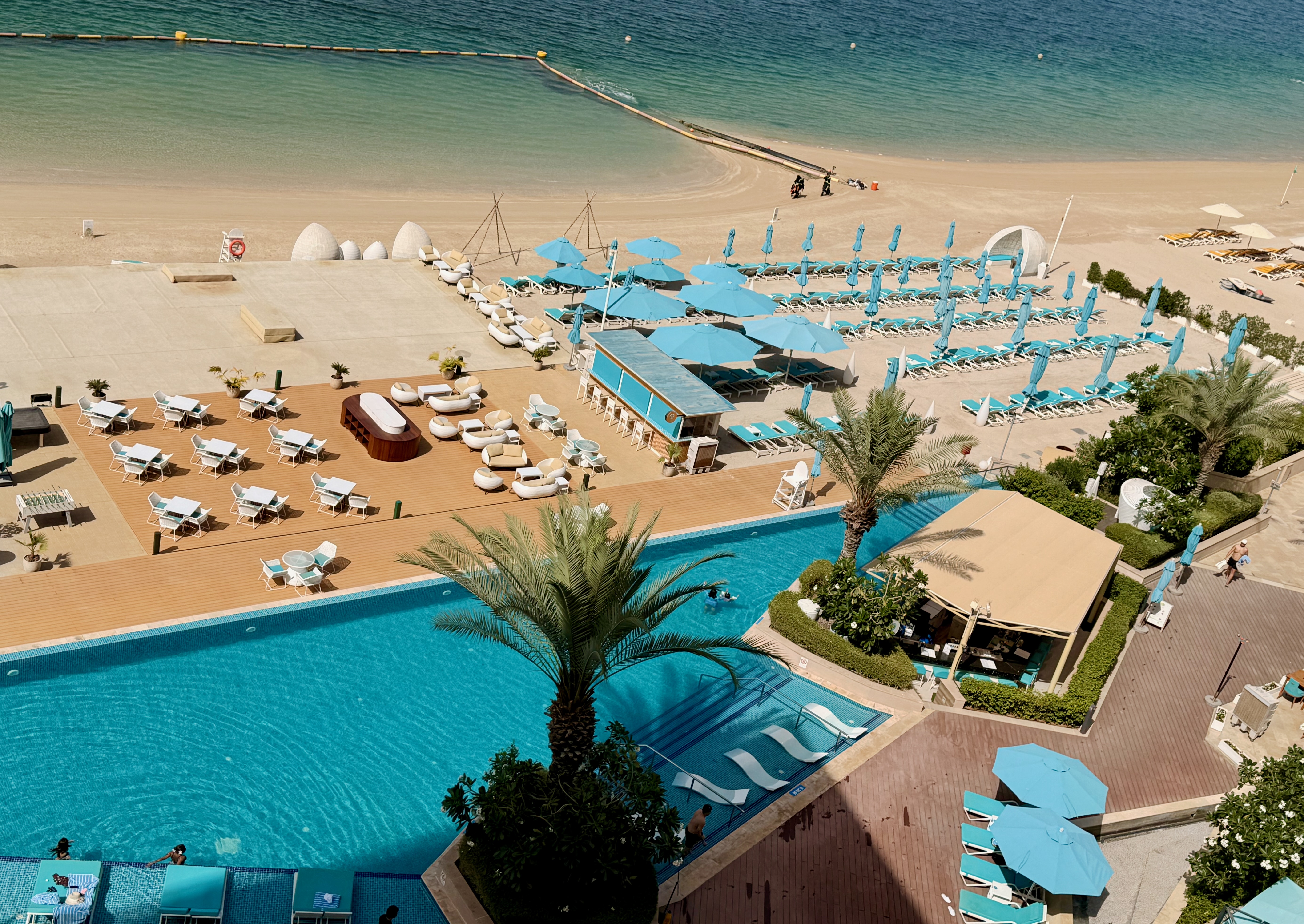 Beach, turquoise pool and sea on Palm Jumeirah, photographed by Brian